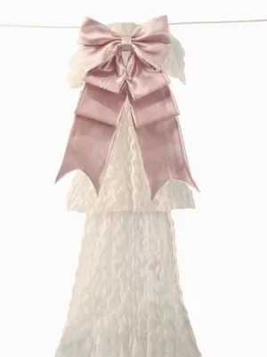 Pink satin double-layer bow accessory with extended ribbon tails displayed in flat front view against clean white studio background, showcasing classic gothic lolita bow design