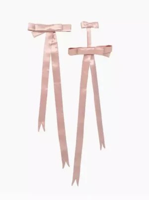 Pink satin ribbon bows with flowing tails flat lay front view, classic lolita hair accessories detail shot on white background