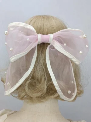 Pink sheer mesh bow lolita hair clip with white fabric trim and faux pearl details, back view on mannequin, sweet rococo aesthetic headwear