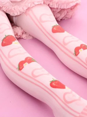 Close-up overhead side view of pink strawberry Lolita socks highlighting the detailed heart frame patterns and multiple strawberry prints across the velvet surface, demonstrating the fine craftsmanship and texture of the Sweet Lolita sock design