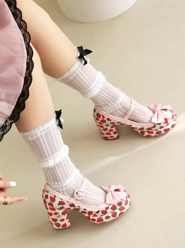 Pink strawberry lolita pumps with front pink bow and strawberry print detail, worn with ruffled sheer socks, back side view light background