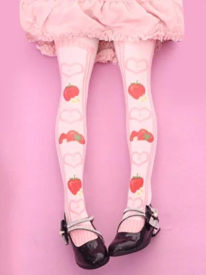 Pink velvet strawberry printed Lolita knee high socks with heart frame patterns, styled with frilly pink skirt and black Mary Jane shoes, showcasing the all-over cute strawberry design and soft pastel aesthetic typical of Sweet Lolita fashion