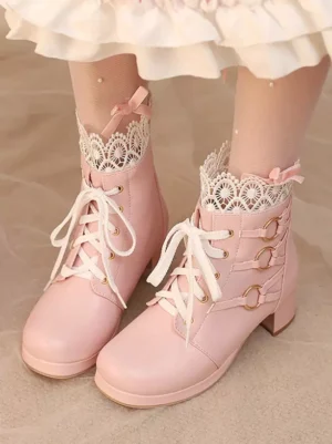Pink sweet lolita ankle boots with round toe and lace collar displayed from front overhead angle, model wearing white ruffled skirt and lace socks, chunky block heel and lace-up design visible