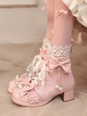 Pink sweet lolita ankle boots with pearl bow details and block heel overhead view with lace socks model wearing boots