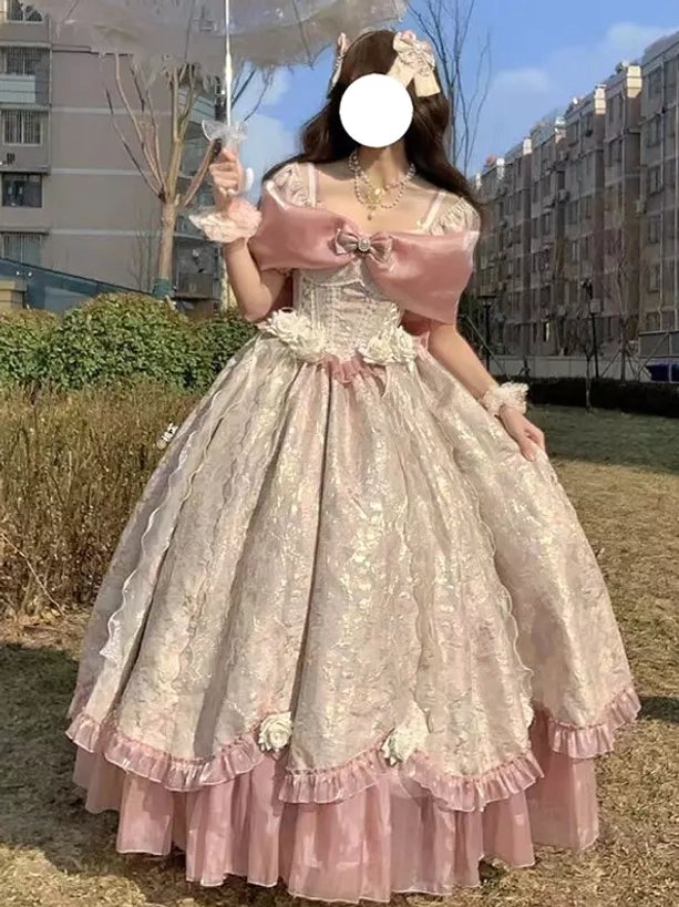 Pink soft lolita ball gown front view with oversized pink front bow, pink layered skirt hem, and 3D flower decorations, female model with flower hairpin in outdoor residential setting