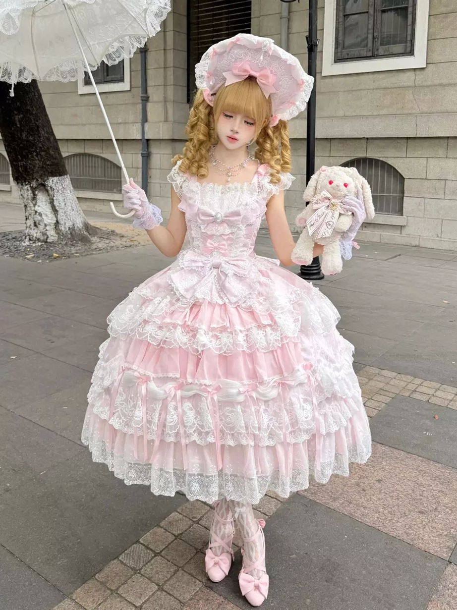 Pink off-shoulder sweet lolita ball gown with tiered lace skirt and matching pink bonnet worn outdoors