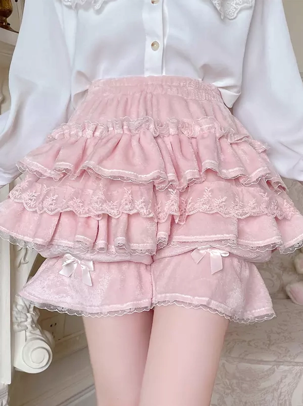 Pink multi-layer Sweet Lolita bloomers lower-body static front view with model in white long-sleeve shirt, displaying pink lace ruffles and velvet hem bows