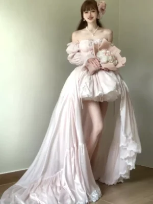 Off-shoulder pink sweet lolita bridal dress with puff sleeves and high-low hem worn by model