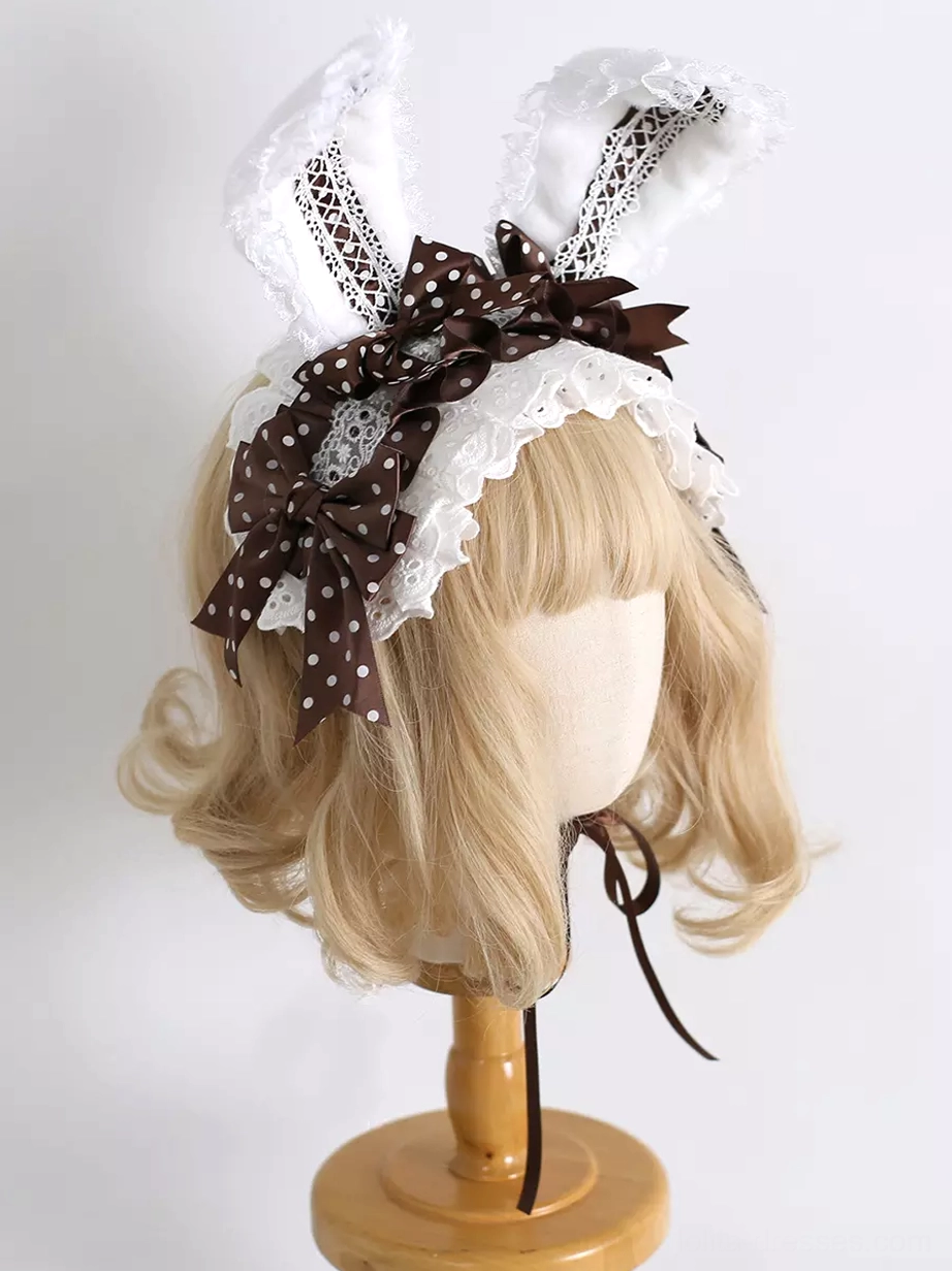 Pink sweet lolita bunny ear headdress displaying rococo aesthetic with ruffled lace and ribbon bows