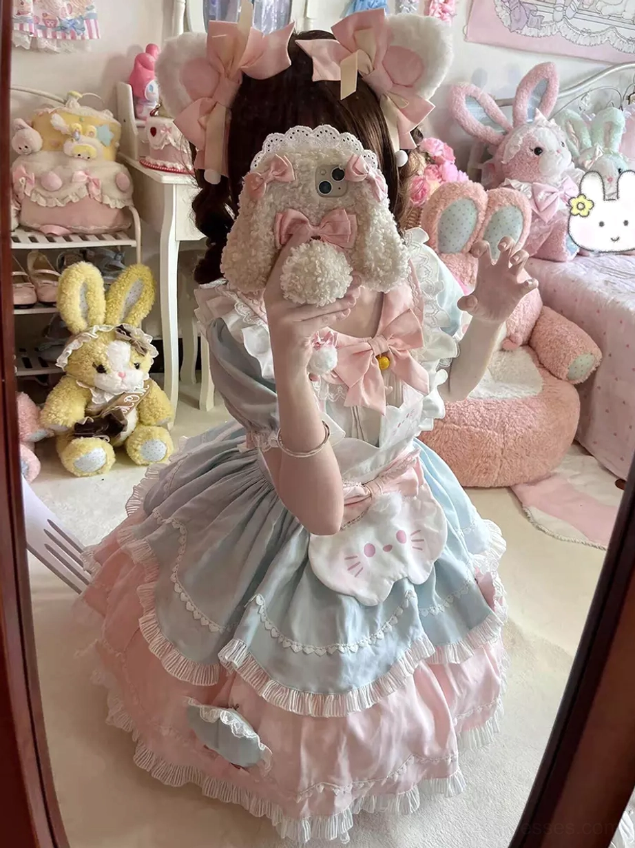 Pink cat-themed sweet lolita dress with oversized bow back view, featuring ruffled layered skirt and cat face appliqué details worn by female model with plush accessories