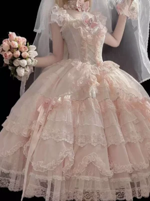 Sweet lolita bridal-inspired pink dress with square neckline, chest satin bow ornament, layered tulle skirt with satin ribbons, model holding bridal bouquet wearing wedding veil