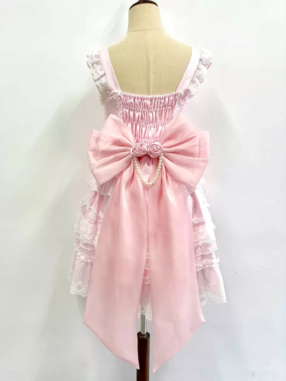 Pink sweet Lolita dress with detachable bow train accessory back view shirred lace ruffled straps