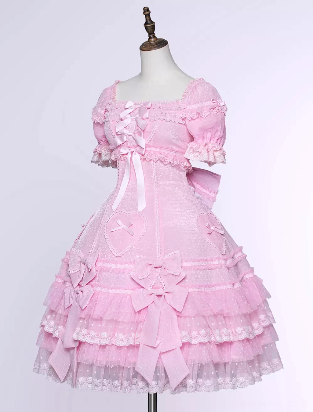 Pink sweet Lolita dress ensemble featuring puff sleeves lace trim bow accents and cascading ruffled skirt layers