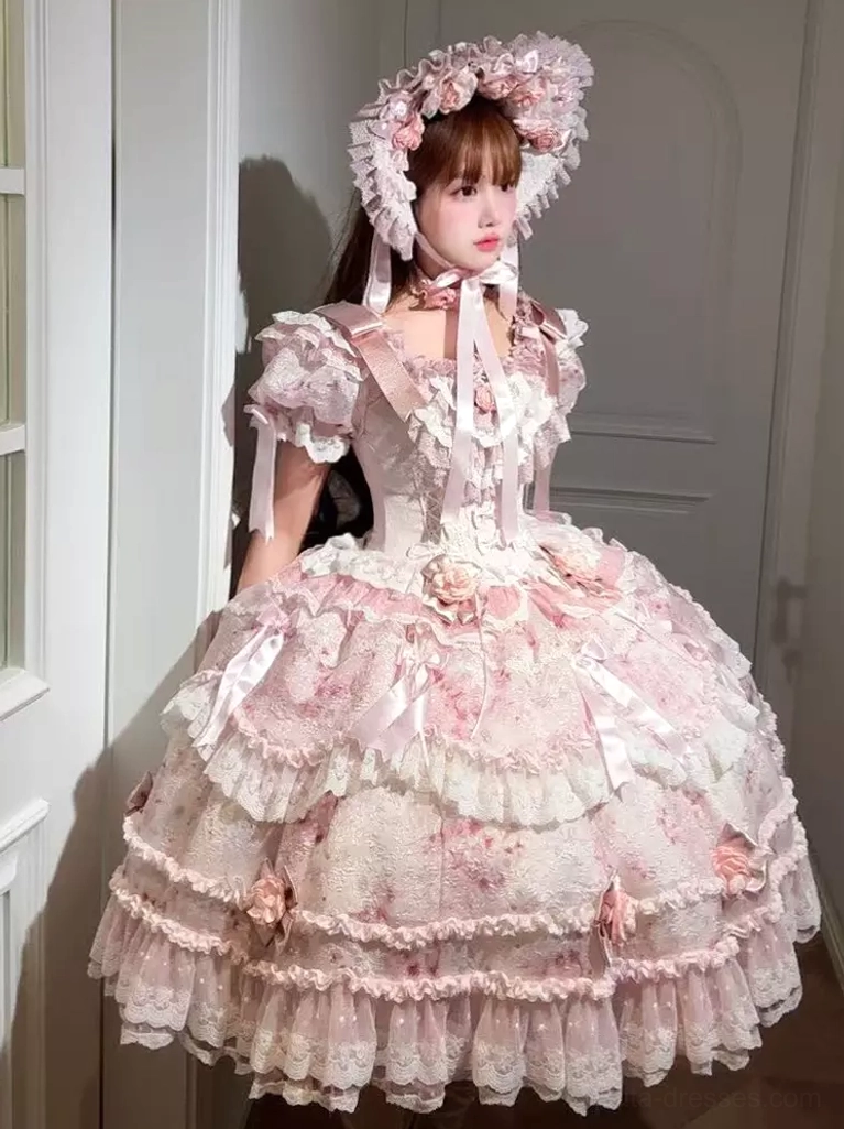 Pink sweet lolita dress front three-quarter view full-body shot showing ruffled short sleeves layered lace skirt 3D dimensional roses matching flower bonnet Victorian aesthetic