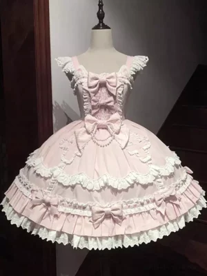 Pink sweet lolita dress front view featuring lace-trimmed bodice, scalloped lace hem, pearl details, coordinated fabric bows, and sleeveless design on mannequin