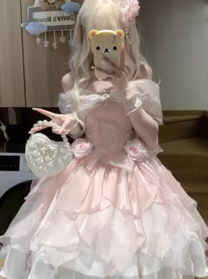 Pink off-shoulder sweet Lolita dress with tiered ruffled skirt front view mirror selfie with blonde model wearing coordinated accessories