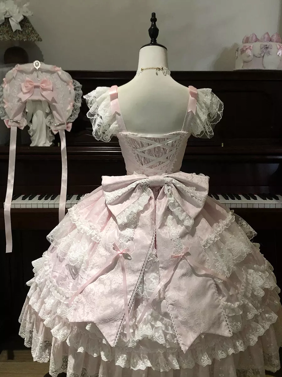 Pink sweet lolita ball gown back view on dress form with open back and matching pink bow bonnet