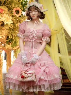 Pink sweet Lolita dress with puff sleeves and layered lace ruffles front full-body view on model