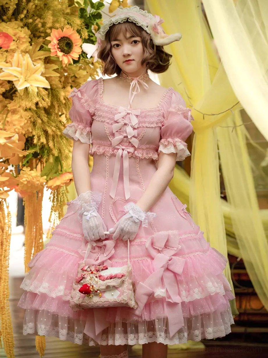 Pink sweet Lolita dress with puff sleeves and layered lace ruffles front full-body view on model