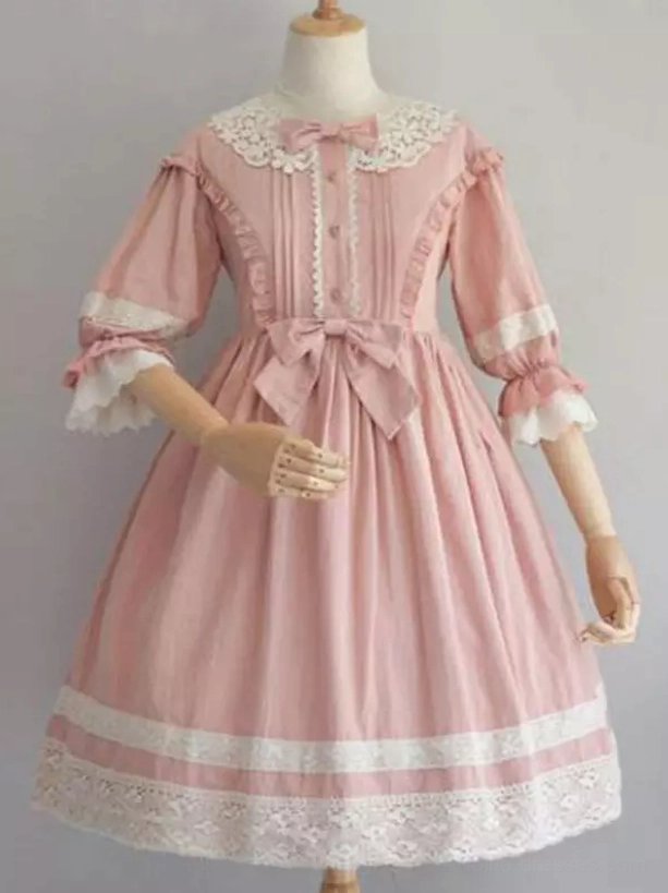 Pink ruffled lolita one-piece dress with lace collar front pintucks and waist bow detail side angle