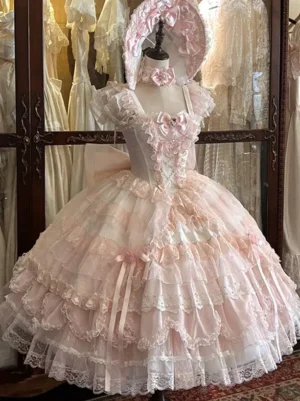 Pink sleeveless sweet lolita dress with multi-layered lace ruffled skirt and satin bow decorations, featuring matching bonnet and choker accessories in vintage showroom setting