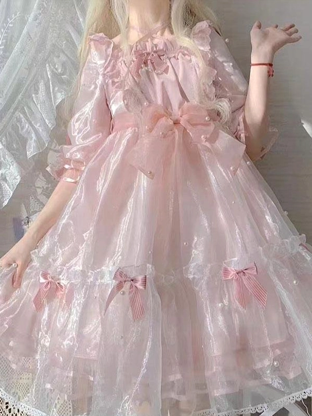 Pink sweet lolita fairy dress close-up front view showing square ruffled neckline large front bow and tiered skirt details