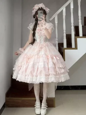 Pink sweet Lolita dress back view showing tiered ruffled skirt layers and rear silhouette with white platform shoes