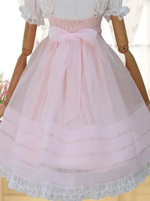Pink sweet lolita JSK rear view showing shirred elastic waist, large back pink bow, ruffled short sleeves construction, and layered sheer striped skirt on articulated mannequin