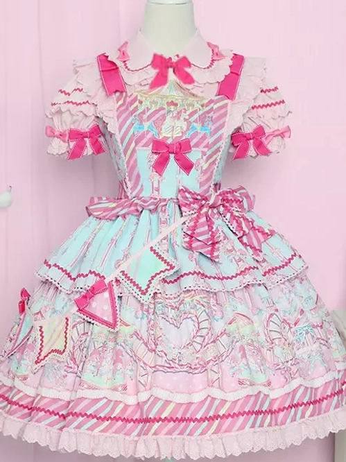 Pink sweet lolita JSK dress front view on mannequin featuring cartoon prints, ruffle bow decorations, and pastel pink aesthetic