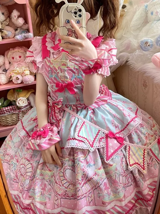 Pink sweet lolita JSK dress detail showcase featuring cartoon prints, ruffle textures, and pastel pink color palette close-up