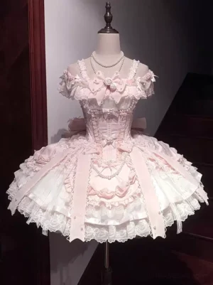 Front view of pink sweet lolita JSK dress with strapless corset bodice, multi-layer ruffled skirt, pearl and lace embellishments, displayed on dress form