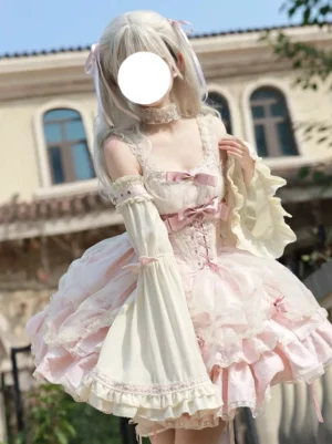 Pink sweet lolita jumper dress with detachable bell sleeves and lace-up corset waist shown in full-length front three-quarter view on outdoor European balcony