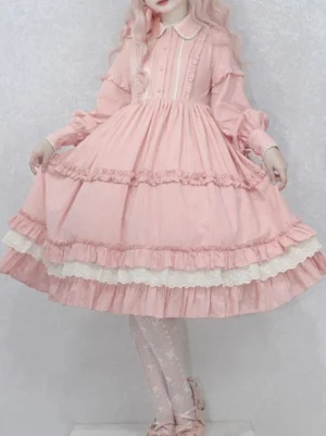 Pink sweet lolita long-sleeve dress front view with Peter Pan collar, A-line silhouette, puffed sleeves, layered ruffled white lace trims, and decorative waist bow - authentic Japanese lolita fashion