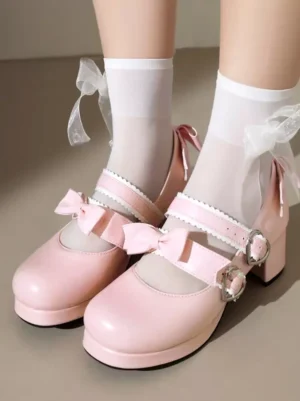 Pink Mary Jane lolita pumps featuring double bow straps and heart-shaped metal buckles with matte PU leather finish, overhead foot shot displaying the iconic Mary Jane silhouette and decorative hardware details