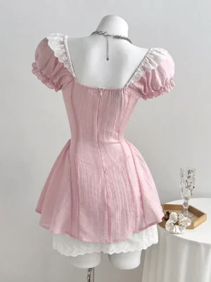 Pink sweet lolita dress back view showing square neckline, back zipper closure, and tiered ruffled lace hem detail