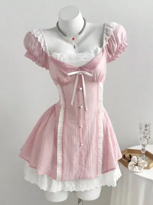 Pink sweet lolita mini dress front view featuring puff sleeves, lace trim, front bow and pearl button details on dress form