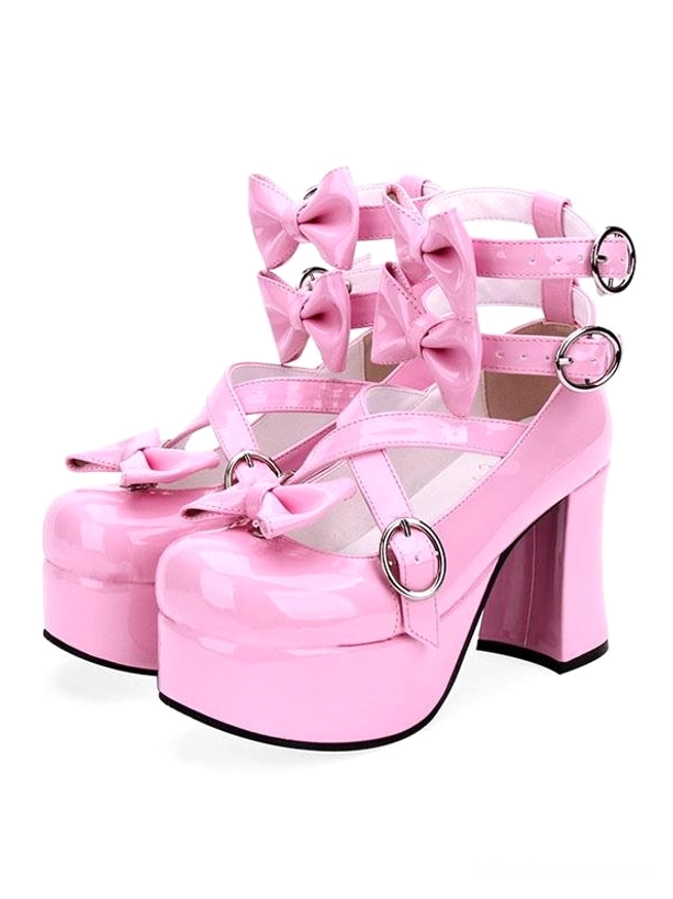 Pair of pink Sweet Lolita platform heels three-quarter front-side view on white background, multiple bow details, adjustable ankle straps with metal fasteners, glossy pink PU leather finish