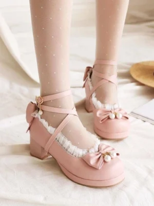 Pink sweet lolita chunky heel pumps with pearl-adorned bow front three-quarter view featuring cross ankle straps ruffled collar and dotted sheer stockings