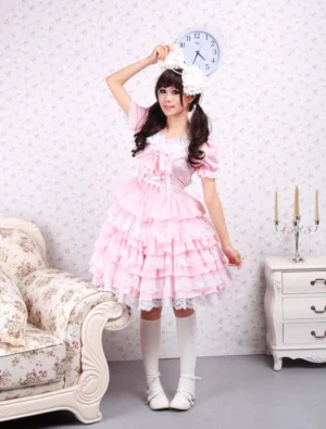 Pink sweet lolita dress with puffed short sleeves and tiered lace skirt full front view on model