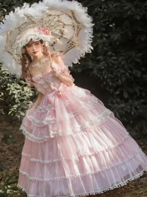 Pink sweet lolita wedding dress with tiered tulle skirt, white lace pom-pom trims, and matching headwear - full front view with floral hat and parasol