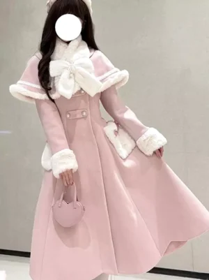 Pink sweet lolita winter cape coat with white fur-trimmed collar featuring large bow detail, model wearing full pink coordinate with heart handbag front view