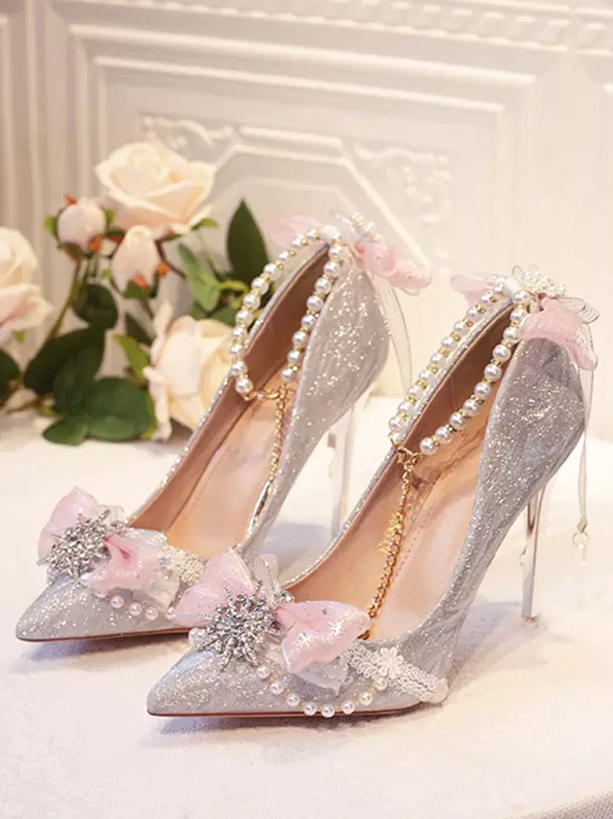 Pink tulle bow silver snowflake crystal pearl toe trims glitter silver upper bridal stiletto heels overhead view with roses
