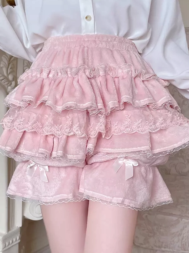 Pink two-tone ruffled Lolita bloomers front lower-body view showing lace-trimmed ruffle layers and delicate hem bow detail with white shirt styling