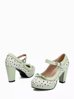 Polka dot Mary Jane pumps side rear view showing matching pair with ankle strap buckle closure and decorative bow embellishment on white background