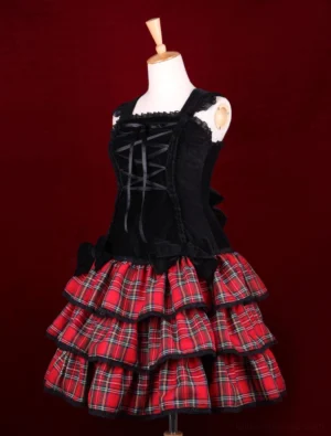 Punk Lolita one-piece dress three-quarter front angle showing corset-style velvet bodice construction with multi-layered red plaid skirt and structured silhouette