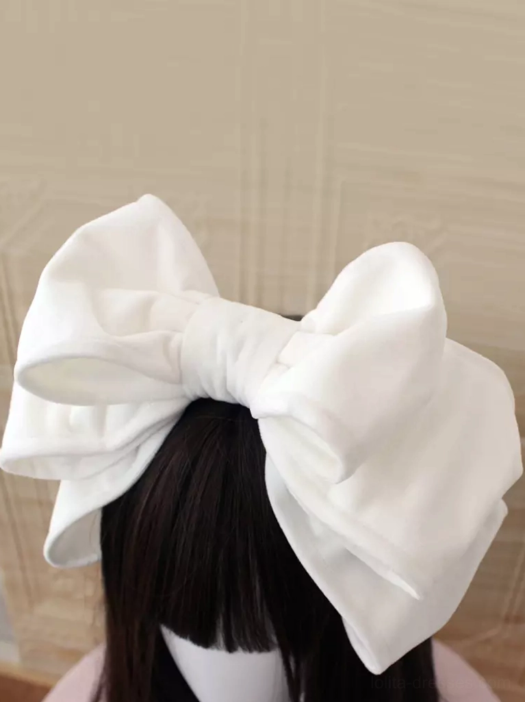Pure white velvet Lolita headdress featuring oversized romantic double-bow silhouette on brown-haired mannequin against light neutral background, versatile for light-colored coordinates