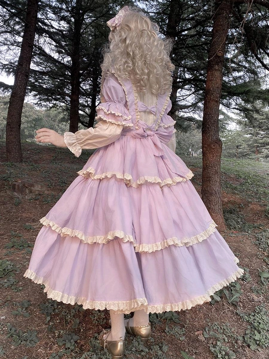 Purple fairy lolita dress back side view with large waist bow tiered ruffled skirt and matching hair bow accessory