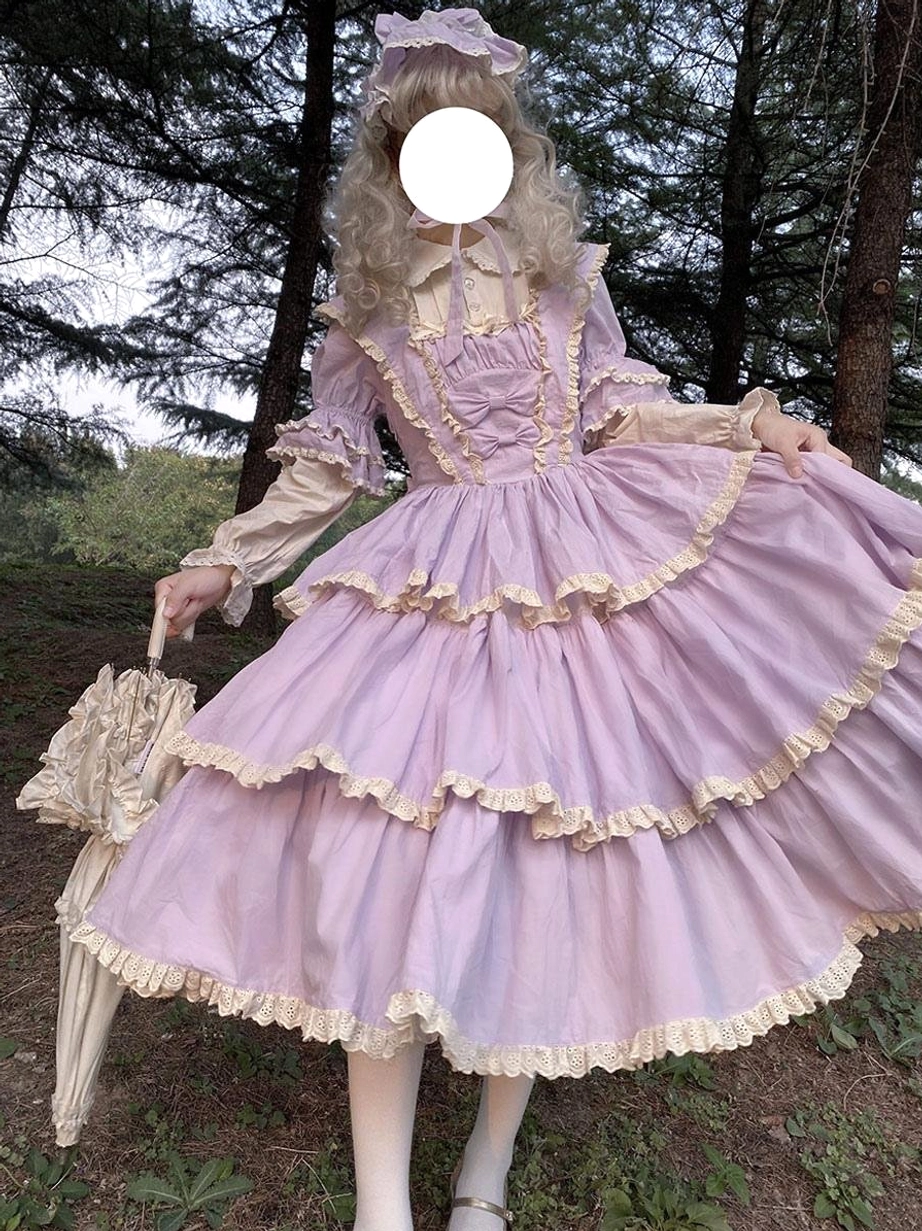 Purple fairy lolita dress front three-quarter view with ruffled layered skirt lace trims matching hair bow and lace umbrella