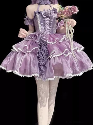 Purple gothic fairy lolita dress front view with off-shoulder halter neckline, tiered white lace-trimmed tulle skirt, rose embellishments, and matching rose choker on model holding pearl chain and flowers