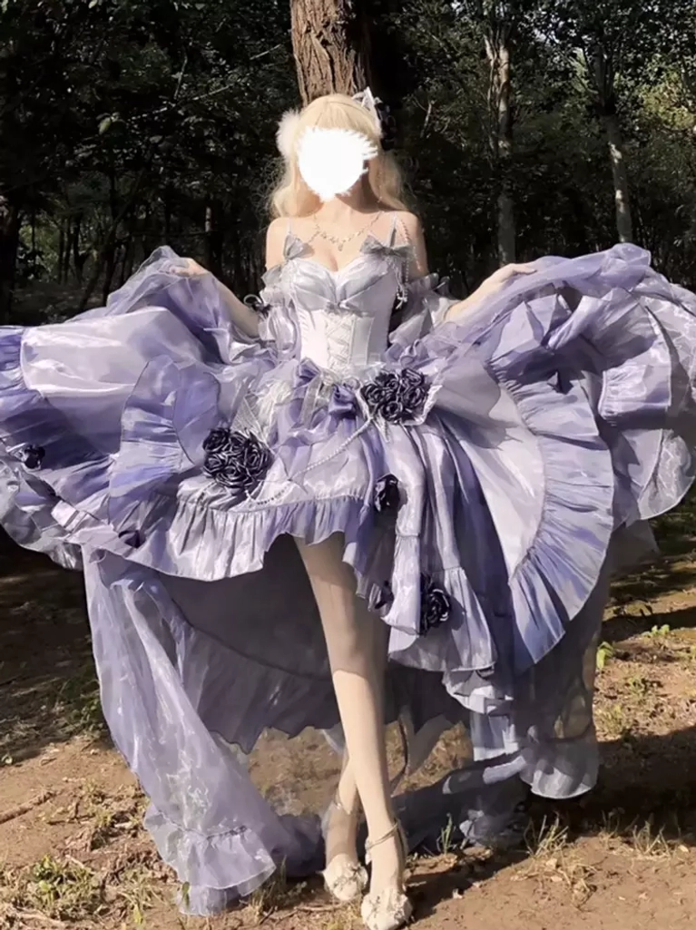 Full outdoor front view of purple high-low lolita fairy dress with flounced spread skirt and model wearing white heels in forest park setting